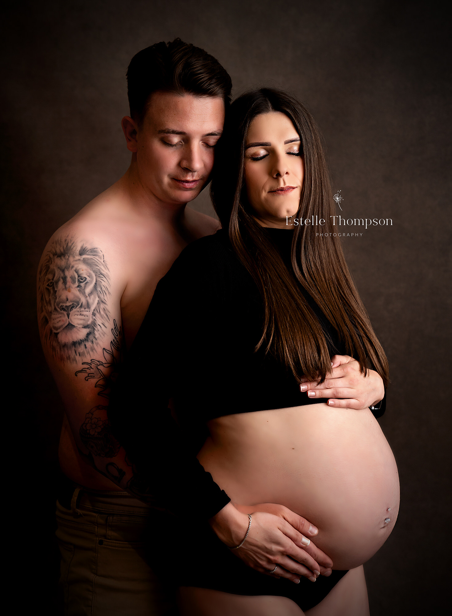 Pregnant lady holds her bump in maternity photoshoot at kent maternity photography studio