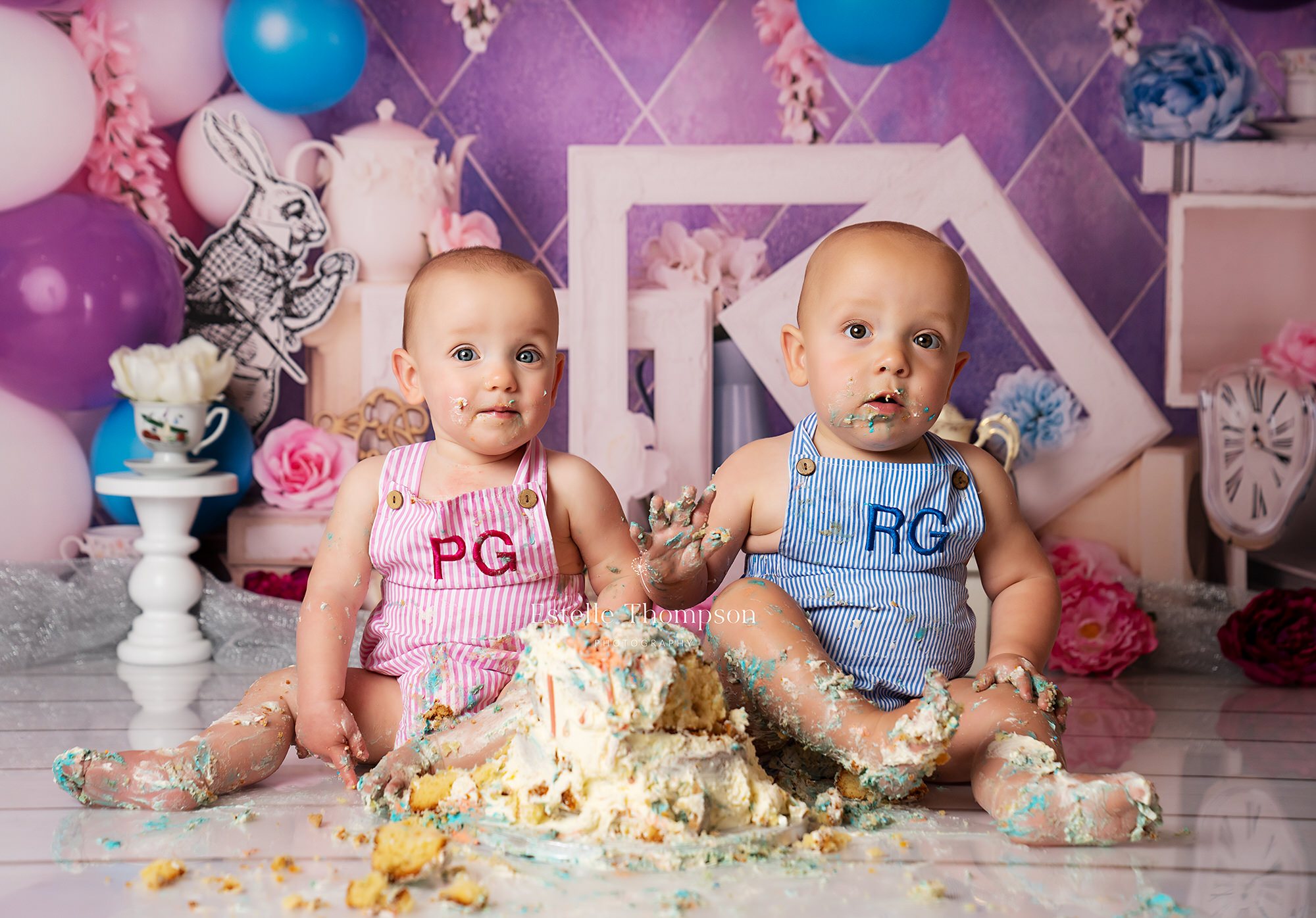 Twins eating birthday cake at first birthday cake smash photoshoot